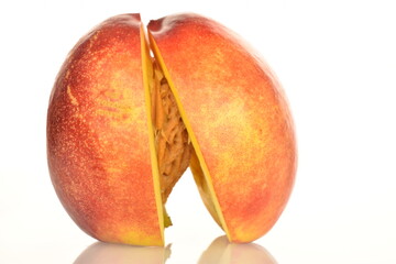 Ripe juicy organic nectarine, macro, on a white background.