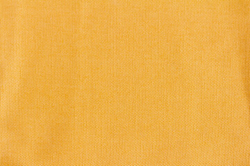 Dense cotton fabric texture of yellow or mustard color.Fabric texture for design and decoration.