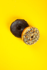 Assorted and colourful gourmet doughnuts on a vibrant yellow background