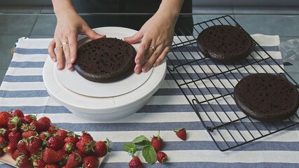 Cooking cake at home. Young attractive housewife cooking a chocolate cake