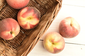 Ripe organic peach, close-up, on a white painted table.