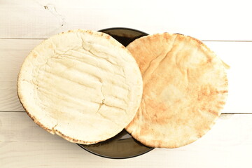 Fresh aromatic pita, close-up, on a wooden table.
