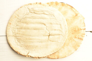 Fresh aromatic pita, close-up, on a wooden table.