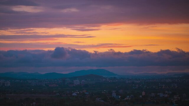 Colorful dramatic sunrise scene timelapse, over the mountains. Wee hours to bright light transition. Selectively focused, shallow depth of field landscape scenery. 