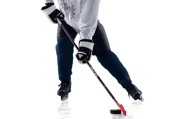 Fototapeta na wymiar Unrecognizable male hockey player with the stick on ice court and white background. Sportsman wearing equipment and helmet practicing. Concept of sport, healthy lifestyle, motion, action. Close up.