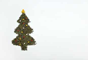 Christmas Tree made of tea on white background. Top view. Christmas and New Year Holidays concept, copy space