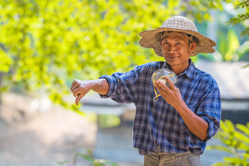 Farmer Asian with smartphone and laptop,Business and technology concept