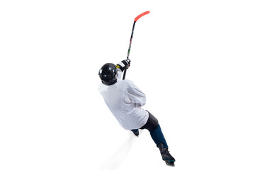 Fototapeta premium Unrecognizable male hockey player with the stick on ice court and white background. Sportsman wearing equipment and helmet practicing. Concept of sport, healthy lifestyle, motion, action. Top view.