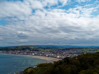 Llandudno promenade, town and beach out into the sea as seen from the Great Orme, in North Wales, United Kingdom.