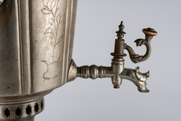 old vintage antique samovar with wooden handles on a gray background