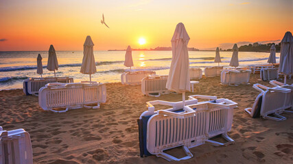 Coastal landscape - Beach umbrellas and loungers on the sandy seashore near town of Nesebar, on the...