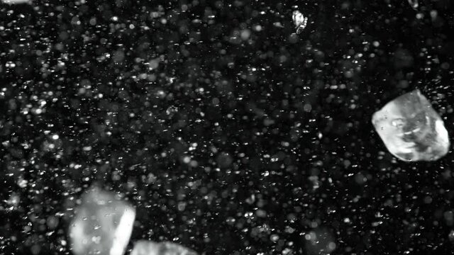 Super slow motion of ice cubes collision on black background. Filmed on high speed cinema camera, 1000 fps.