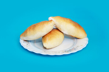 baked dough pies with filling on a plate