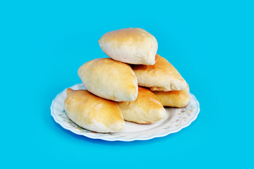 baked dough pies with filling on a plate
