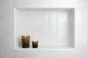 The luxury lighting aromatic scent glass candle display in the luxury design white toilet bathroom