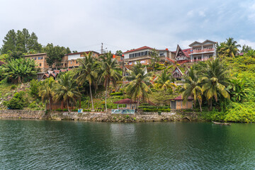Fototapeta premium The island Samosir and peninsula Tuktuk Siadong with its resorts, within the Lake Toba, the biggest volcanic lake in the world located in the middle of the northern part of the island of Sumatra 