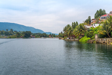 Fototapeta premium The island Samosir and peninsula Tuktuk Siadong with its resorts, within the Lake Toba, the biggest volcanic lake in the world located in the middle of the northern part of the island of Sumatra 