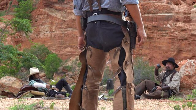 Cowboys duel with enemies that are resting in the camp.