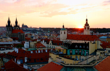 Most Prague through the eyes of birds with magnificent sunset and sky over the traditional houses with red roofs.
