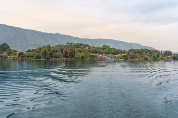 The island Samosir and peninsula Tuktuk Siadong with its resorts, within the Lake Toba, the biggest volcanic lake in the world located in the middle of the northern part of the island of Sumatra