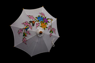 Thai vintage cloth umbrella is public  nation art of Thailand in dark background.