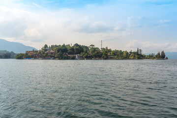 Fototapeta premium The island Samosir with the peninsula Tuktuk Siadong within the Lake Toba, the biggest volcanic lake in the world located in the middle of the northern part of the island of Sumatra 