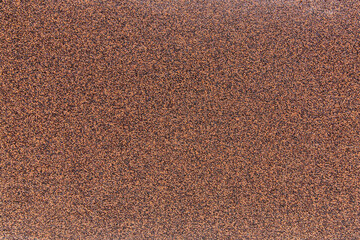 ruberoid texture of roofing material bituminous coating with stone chips to protect the roof of the house from moisture and rain, roofing material surface closeup.