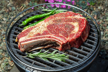 raw cowboy steak on grilled