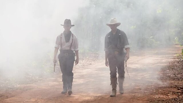 Slow motion pictures of two cowboy men traveling