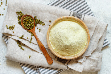 Bowl of mung beans flour and grain in spoon