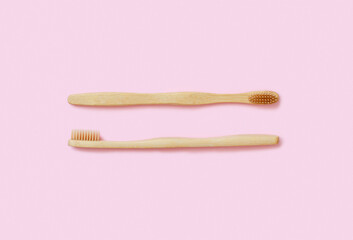 Eco friendly bamboo toothbrushes on pink background