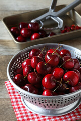 removing pitts from cherries in colander