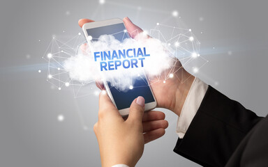 Female hand touching smartphone with FINANCIAL REPORT inscription, cloud business concept