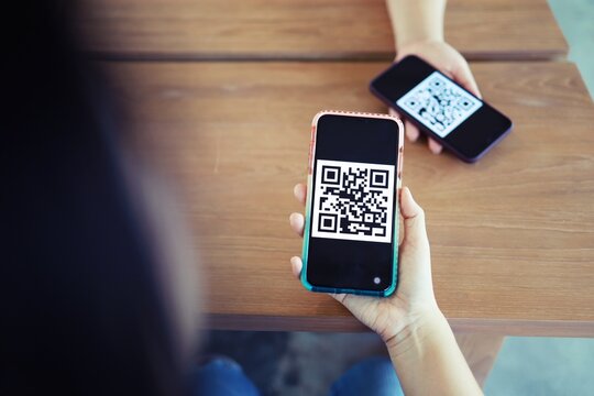 Qr code payment. Woman scanning QR code online shopping cashless technology concept.