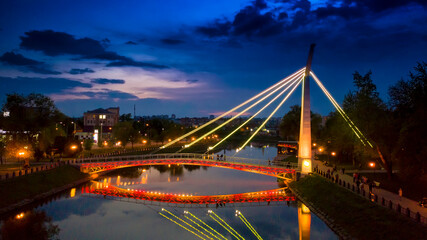 Fototapeta na wymiar Glowing bridge on the waterfront.