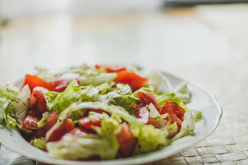 Vegetable salad with tomatoes, iceberg lettuce, onions and soy sauce.