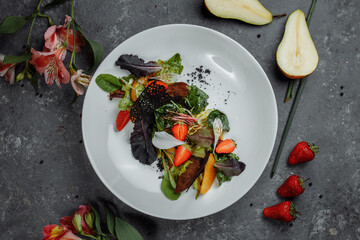Salad with duck breast. Su-view duck fried in Teriyaki sauce, caramelized pear, tomatoes, salad mix, citrus sauce. copyright place