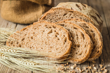 Loaf of bread on rustic wood background copy space.