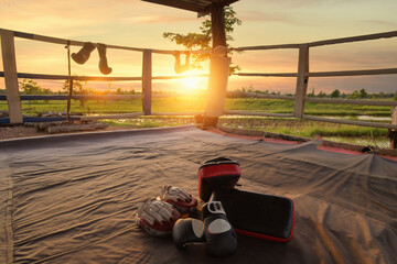 Leather mitt glove placed on canvas of ring in camp of training boxer,Used for Muay Thai, Kick...