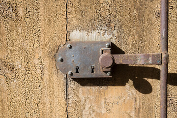 antique door lock on a wooden gate