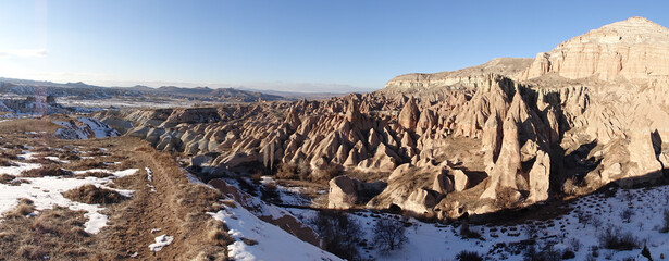 Cappadocia cone-shaped rock formations near the city of Göreme with snow during winter in central Turkey. © Christopher