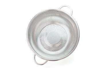 Metal kitchen utensils, Stainless steel colander on a white background. Top view