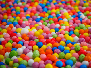 Fototapeta na wymiar Background texture of multicolored foam balls; short focus