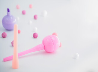 A scattering of pink, violet and lilac markers and balls, short focus,  place for text