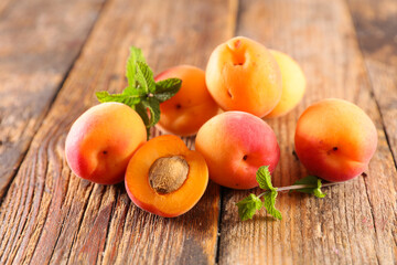 Naklejka na ściany i meble fresh apricot on wood background