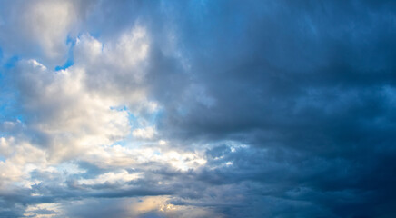 Naklejka na ściany i meble Sky with white and dark dramatic storm clouds