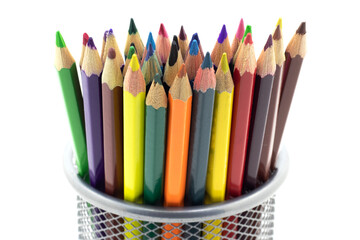 Close up of colored pencils in a metal stand on a white isolated background