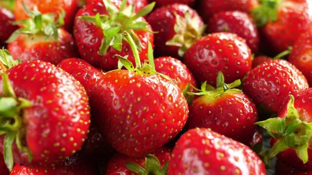 rotating turning roud red uncut  riped strawberries