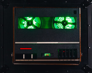 reel to reel audio tape recorder with green led light strip. VU meter with 
