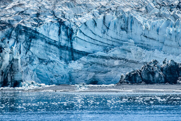 An impressive  view of the cliff of Reid Glacier  with many icebergs in the fore ground, in Glacier Bay National Park & Preserve ,  Alaska
